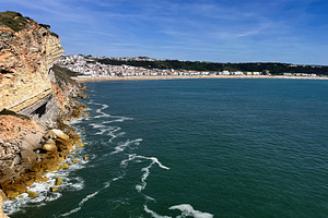 Scenic coastal view of Nazaré with cliffs, ocean, and sunny skies, a Photo by AS photostudio