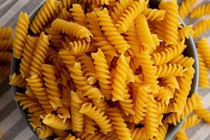 Dry Fusilli Pasta in a Bowl, top view. Flat lay, overhead, from, a Food & Drink Photo by LiudmylaChuhunova