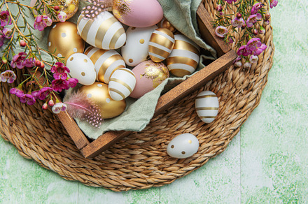 Easter decor. Colored Easter eggs in a wooden box on the table., a Holiday Photo by Olena Rudo