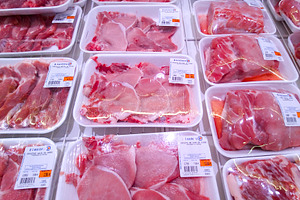 Packaged raw pork meat in supermarket refrigerator, a Food & Drink Photo by DanFLCreativo
