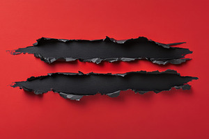 Black paper ripped on red background, a Photo by Beautiful things
