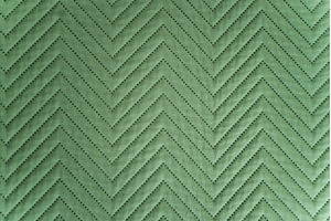 Close-up of quilted green fabric, a Background Photo by volodymyrshtun13795