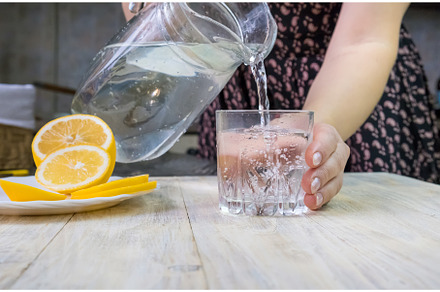 The girl pours water with lemon, a Person Photo by yanadjana