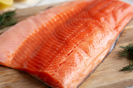 Organic Raw Salmon Fillet on a wooden board, side view., a Food & Drink Photo by LiudmylaChuhunova