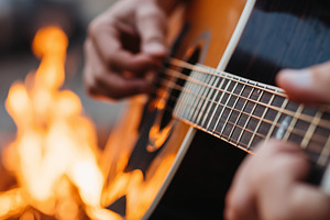 Close up of a man playing on guitar, a Person Photo by MistyDay