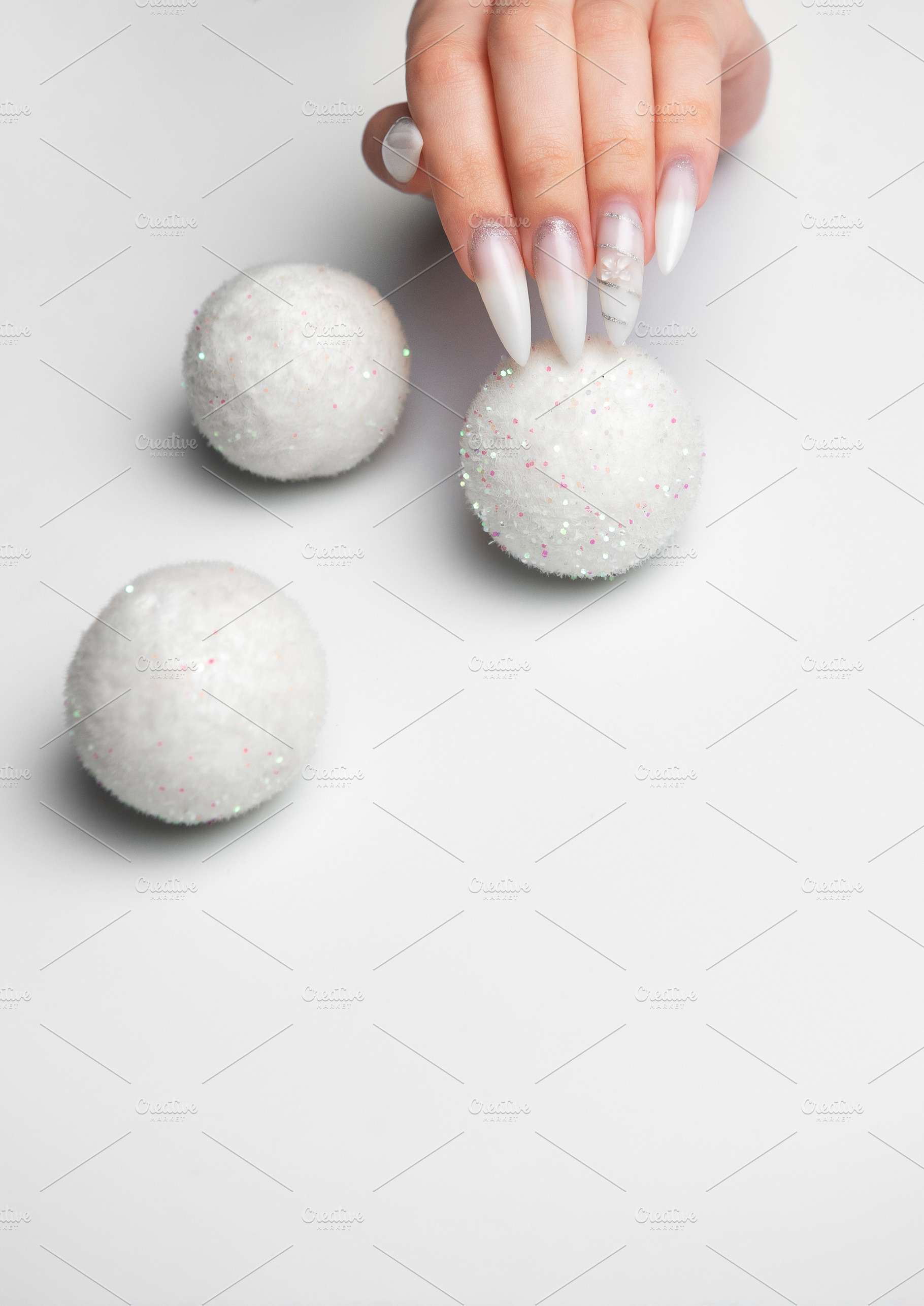 Female hand holding snow globe with winter manicure style, a Beauty & Fashion Photo by Olena Rudo