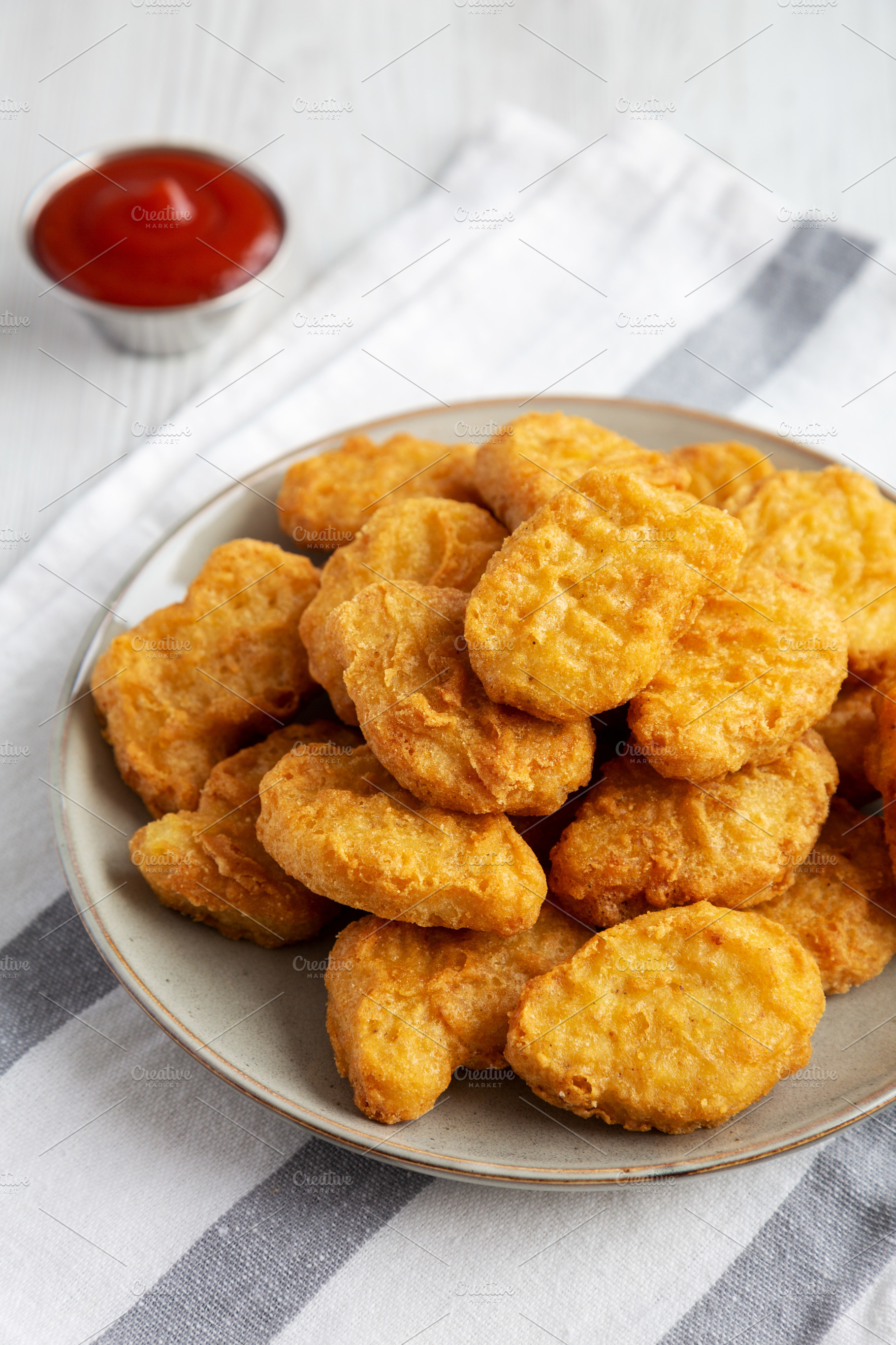 Homemade Chicken Nuggets with Ketchup, side view., a Food & Drink Photo by LiudmylaChuhunova