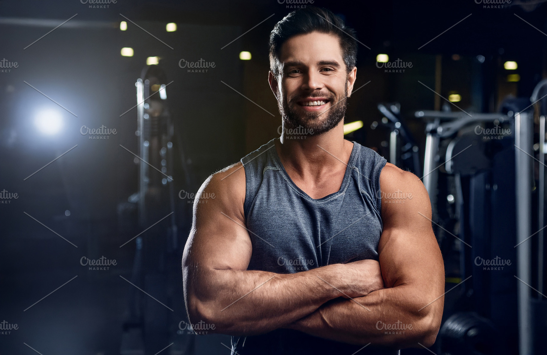 Gym trainer in dark gym with weight machines in background, a Sports & Recreation Photo by Davizro's Market
