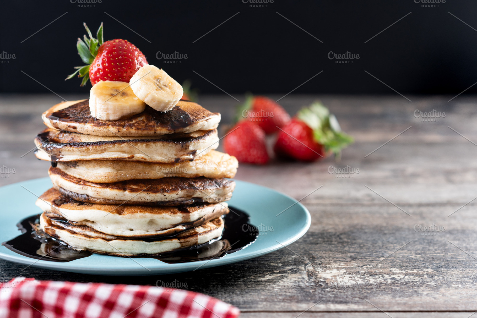 Pancakes with chocolate and fruit on wooden table, a Food & Drink Photo by etorres69