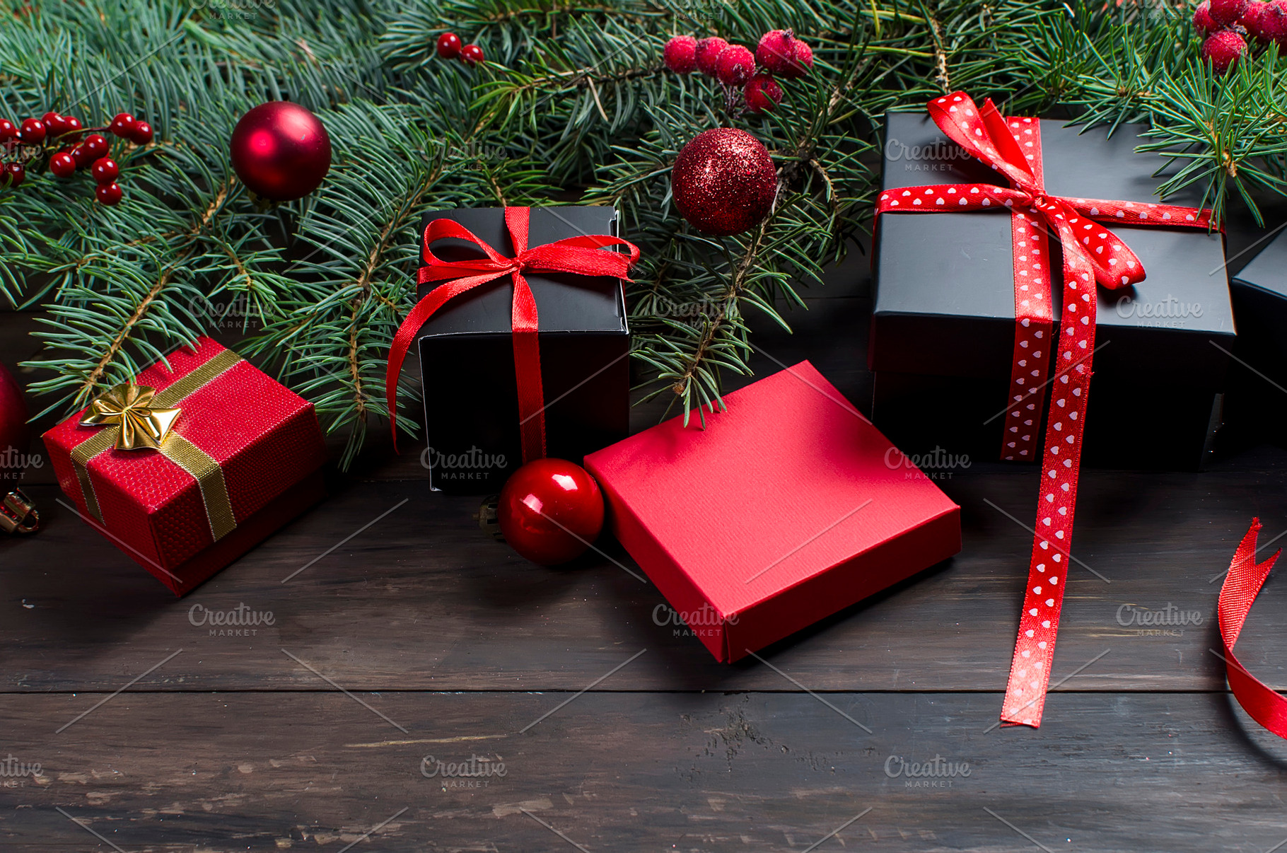 Black and red christmas gift box with red ribbon and fir bran, a Holiday Photo by vimart