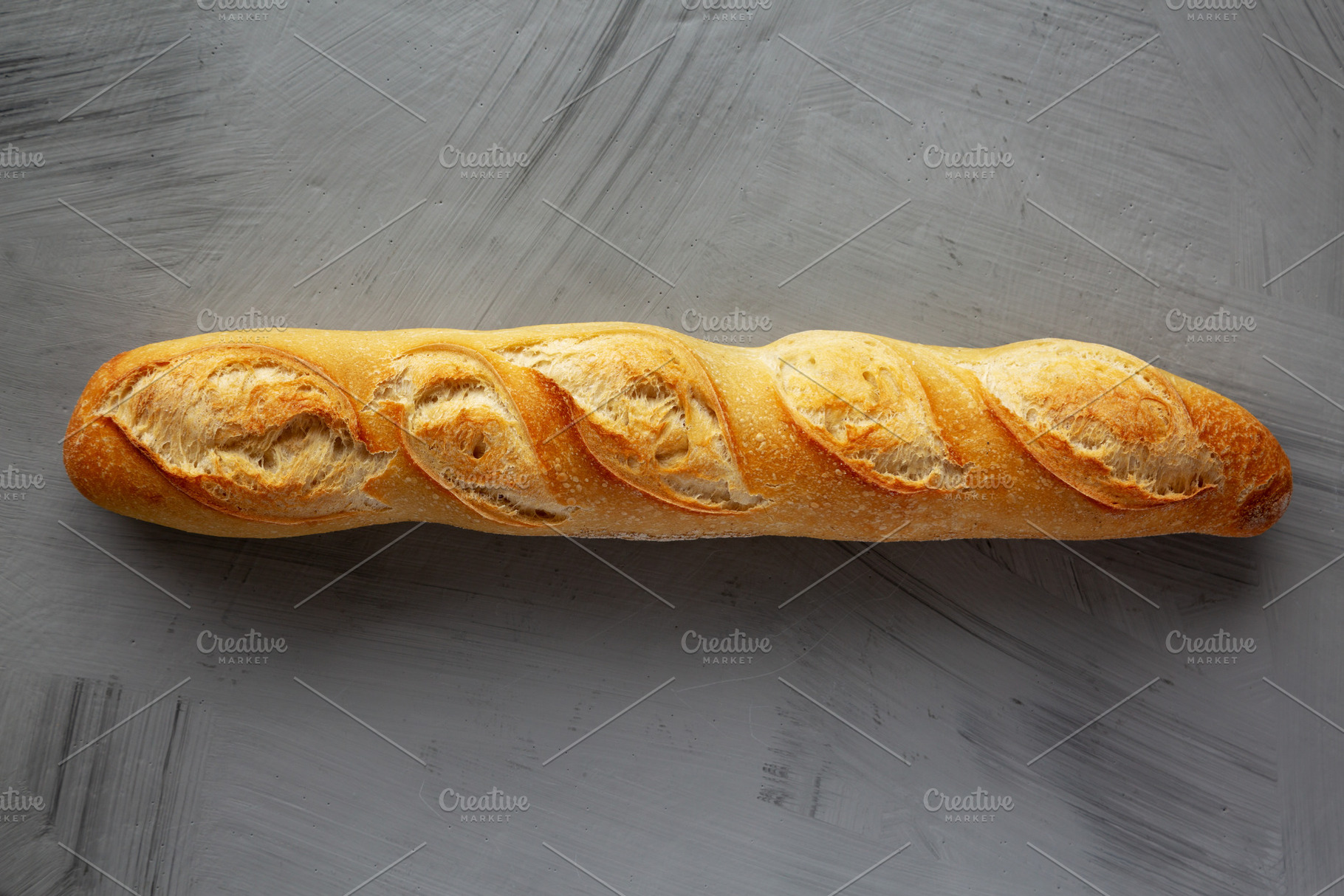 Homemade French Bread Baguette on a gray background, top view., a Food & Drink Photo by LiudmylaChuhunova