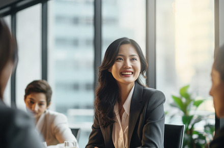 Asian female CEO with long hairs confidently leading a diverse boardroom meetin