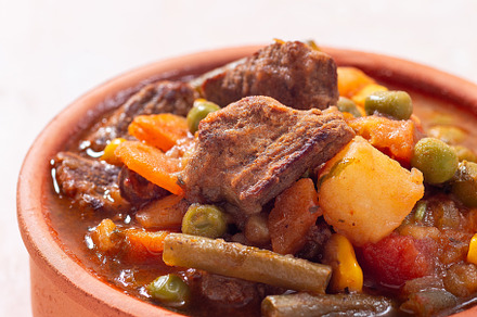 Delicious beef stew with potato, green beans, carrot, peas and corn, in ceramic, a Food & Drink Photo by iuliia_n