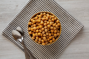 Organic Raw Canned Chickpeas in a Bowl, top view., a Food & Drink Photo by LiudmylaChuhunova