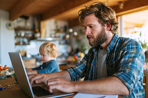 Balancing work and play while working from home with a child nearby, a Person Photo by AlyaAnd