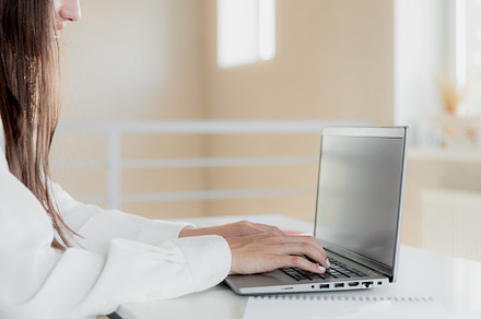 Woman hands typing on the laptop with blank white screen mockup laying on table, a Technology Photo by Lenor4ik