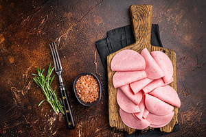 Overhead view of cold cuts (mortadella) garnished with rosemary, a Food & Drink Photo by composter-box@mail.ru