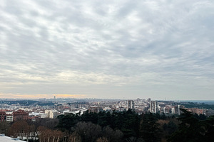 Panoramic view of Madrid cityscape during a cloudy day with skyline visible, a Photo by AS photostudio