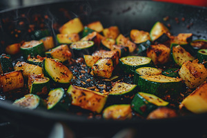 Grilled zucchini pieces in pan, a Food & Drink Photo by AlyaAnd
