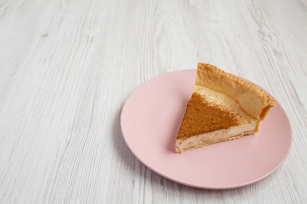Homemade Sugar Cream Pie on a pink plate on a white wooden backg, a Food & Drink Photo by LiudmylaChuhunova