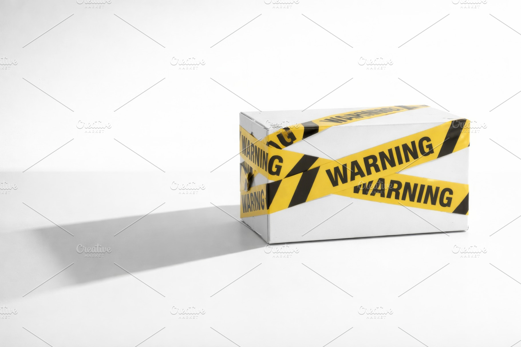 Warning tape wrapped around white bo, a Photo by Dvoevnore photos