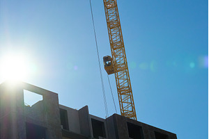 Two large cranes stand tall against, an Industrial Photo by darksoul72
