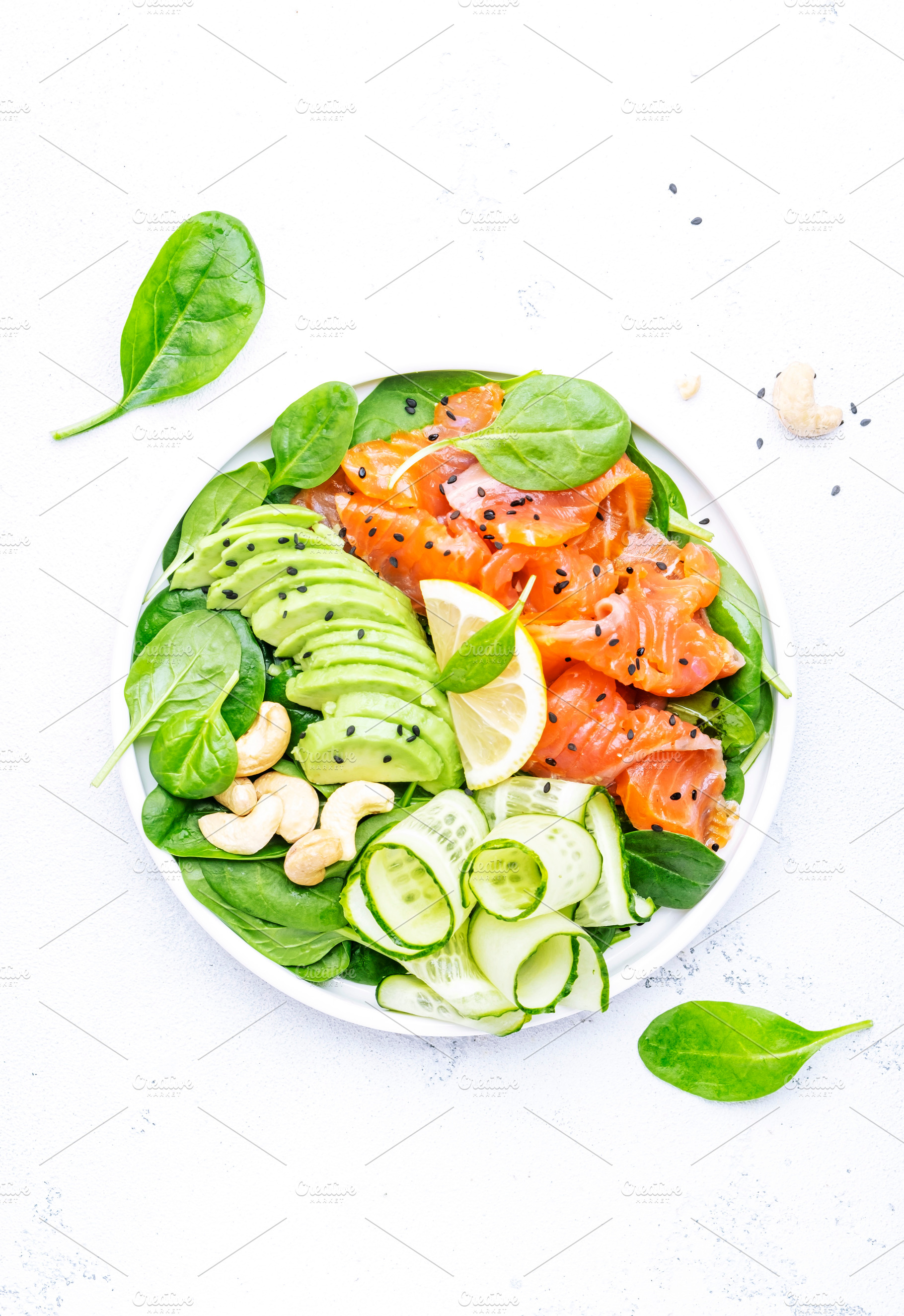 Salmon salad for ketogenic diet with avocado, spinach, cucumber,, a Food & Drink Photo by 5PH
