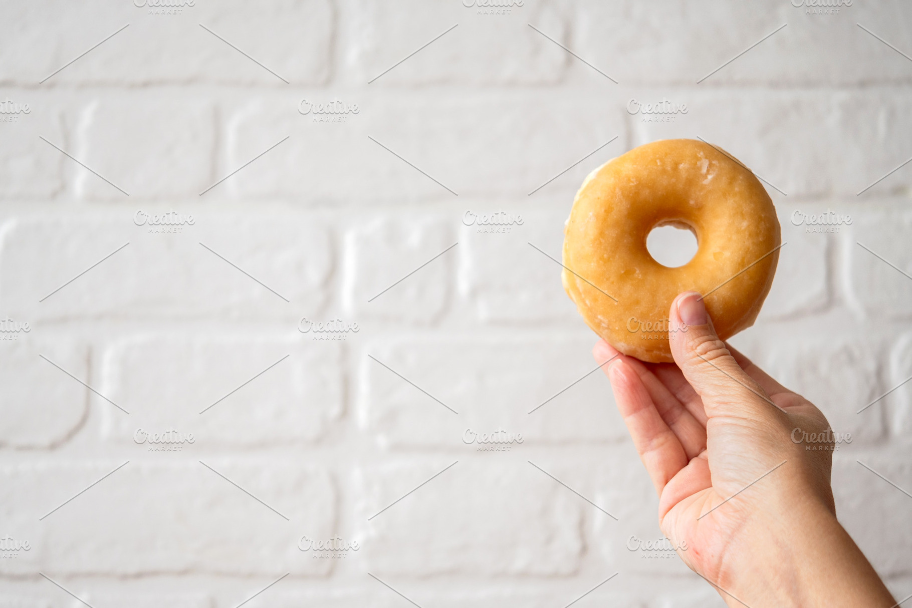Hand Holding Glazed Donut, a Food & Drink Photo by etorres69
