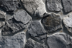 Close-up of irregular dark gray stone wall, rough surface patter, an Animal Photo by Ales Munt