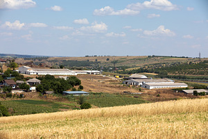 Cluster of agricultural buildings and houses in a dry rural land, an Architecture Photo by Ales Munt