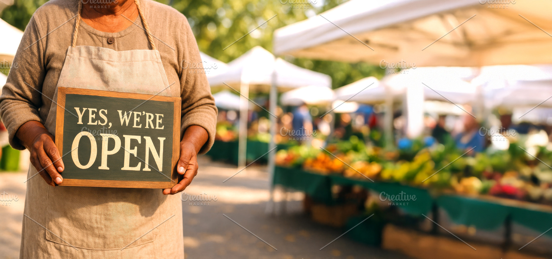 Farmers market vendor holding Yes, w, a Photo by Dvoevnore photos