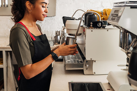 Side view of a female barista, a Business Photo by Artem Varnitsin