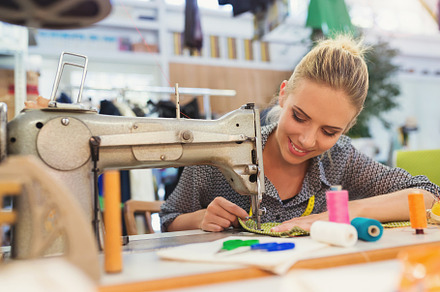 Young woman with sewing machine featuring sewing, woman, and machine, a Person Photo by HalfPoint