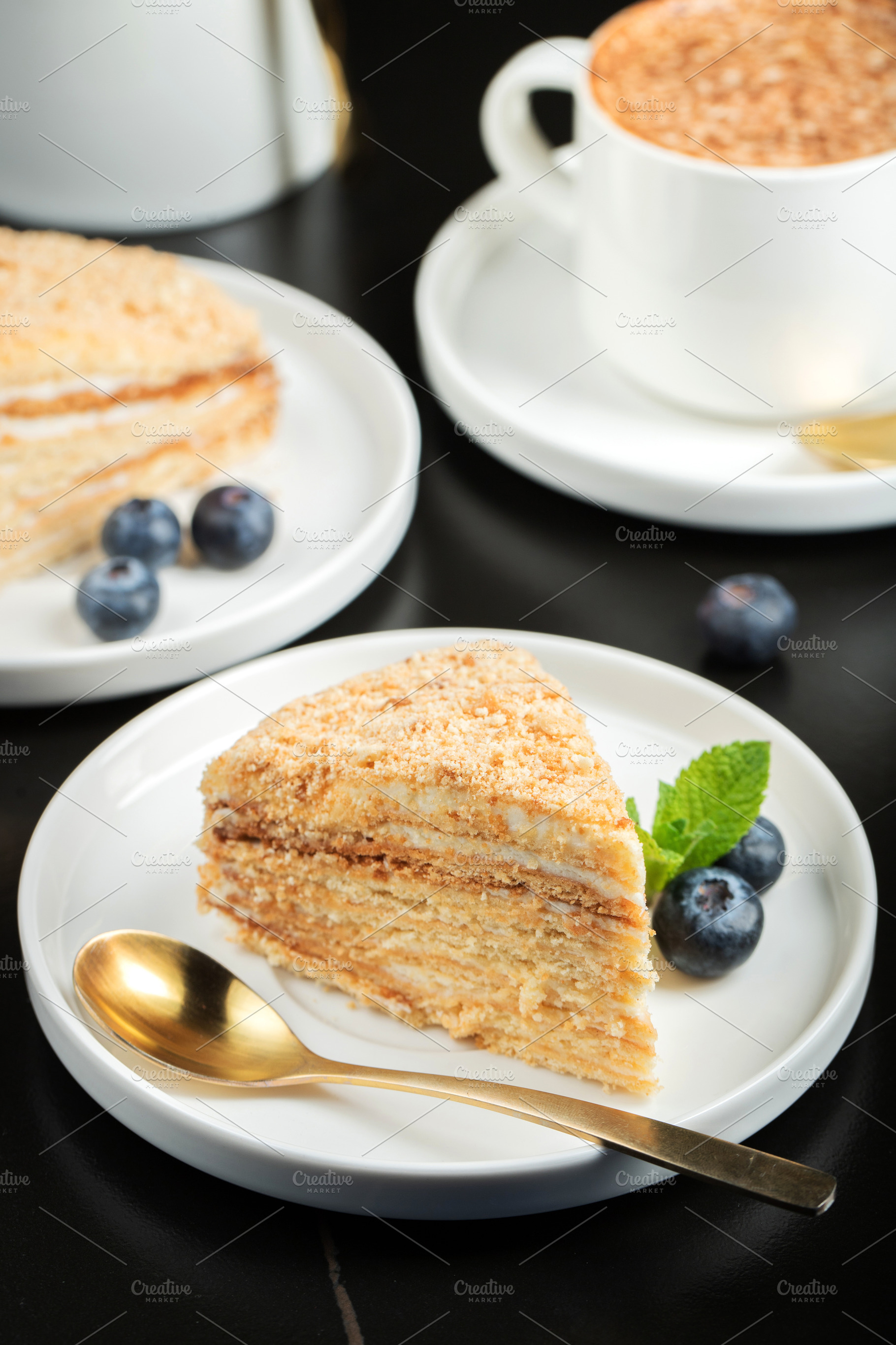 Medovik. Honey cake made from honey cakes with whipped sour cream, decorated wi, a Food & Drink Photo by Budarinphoto