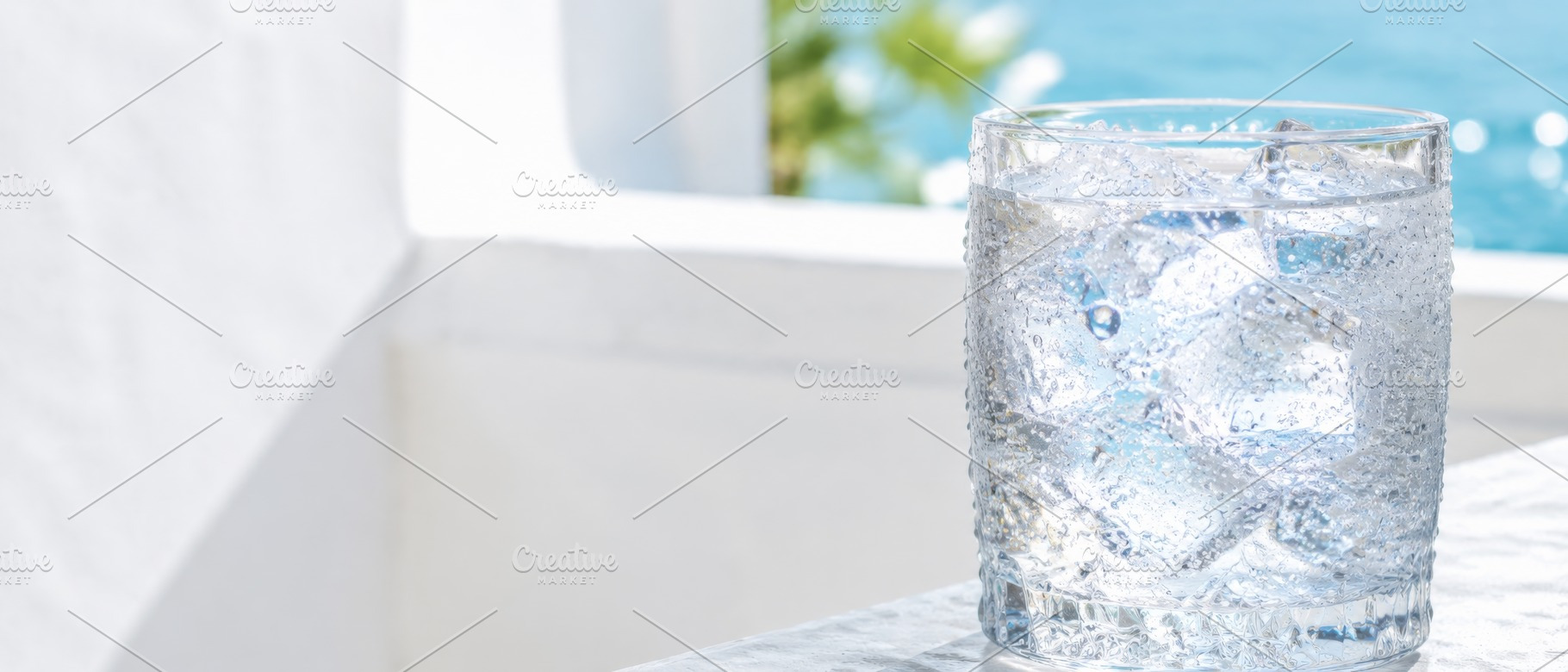 Glass of ice water on sunny day capt, a Photo by Dvoevnore photos