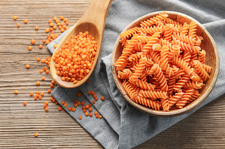 Fusilli red lentil pasta on a old wooden background., a Food & Drink Photo by Olena Rudo