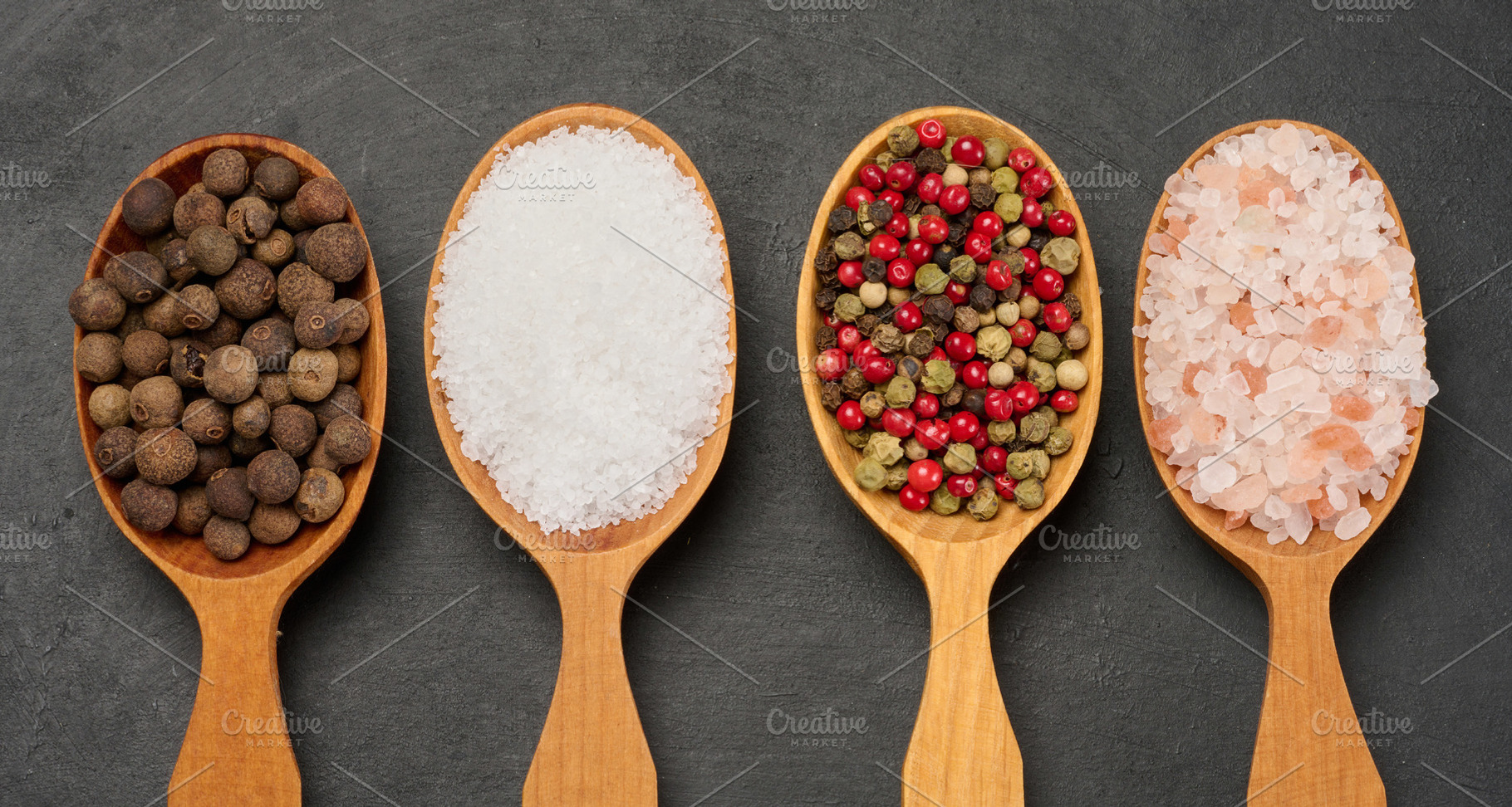 Horizontal row of wooden spoons with black pepper, salt, mixed p, a Food & Drink Photo by ndanko