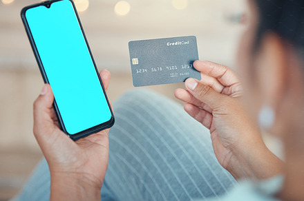 Credit card, woman with phone in hand and mockup space for online shopping, ecommerce and payment. Fintech, finance and online payment with digital, internet and bank website app on smartphone., a Photo by Peopleimages.com