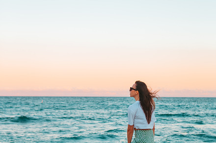Young happy woman on the beach enjoy her summer vacation, a Person Photo by travnikovstudio