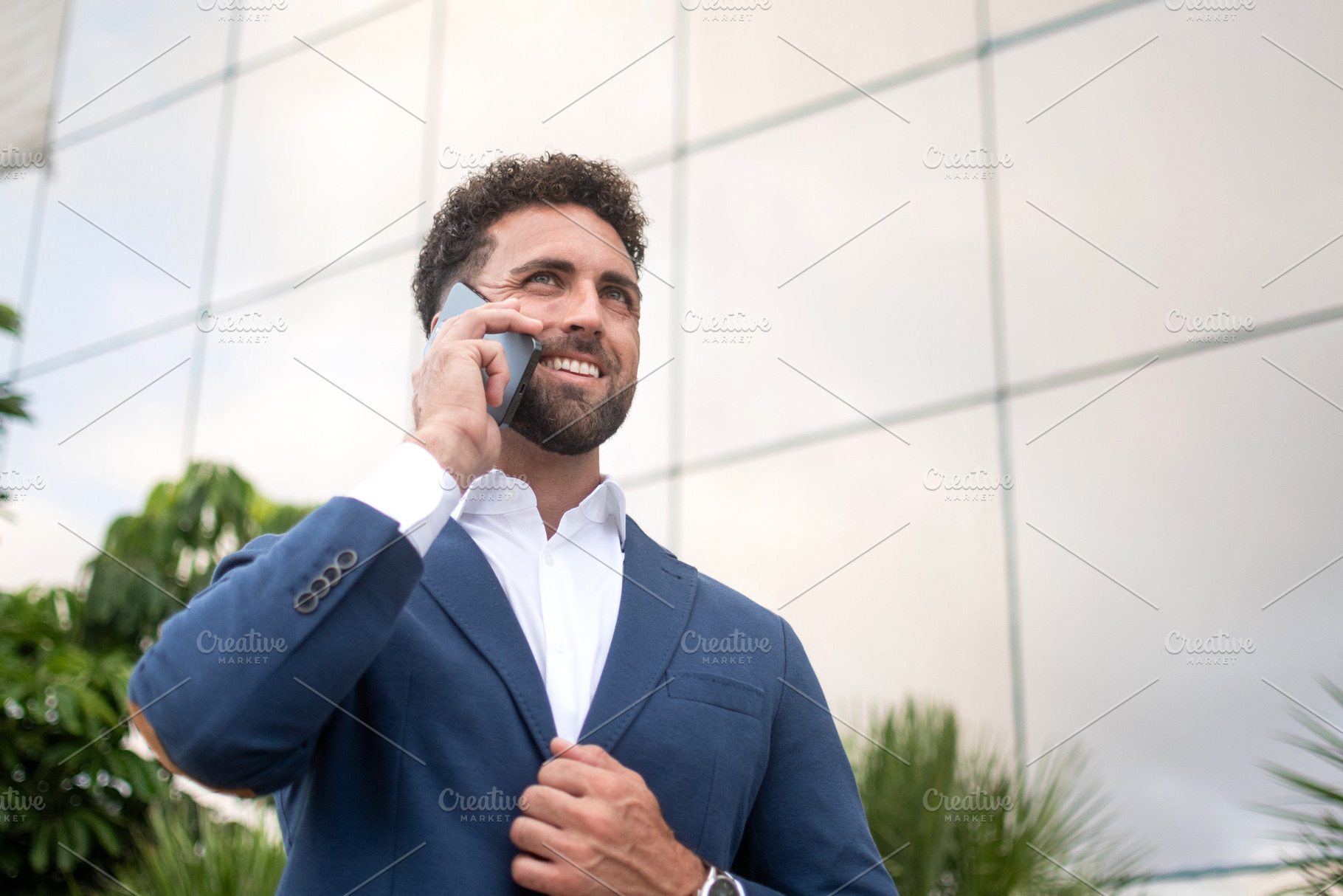 Smiling businessman holding smartphone, a Business Photo by etorres69