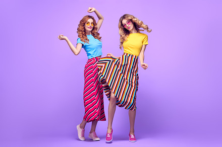 Two girls fooling around fashion containing two, girl, and jumping