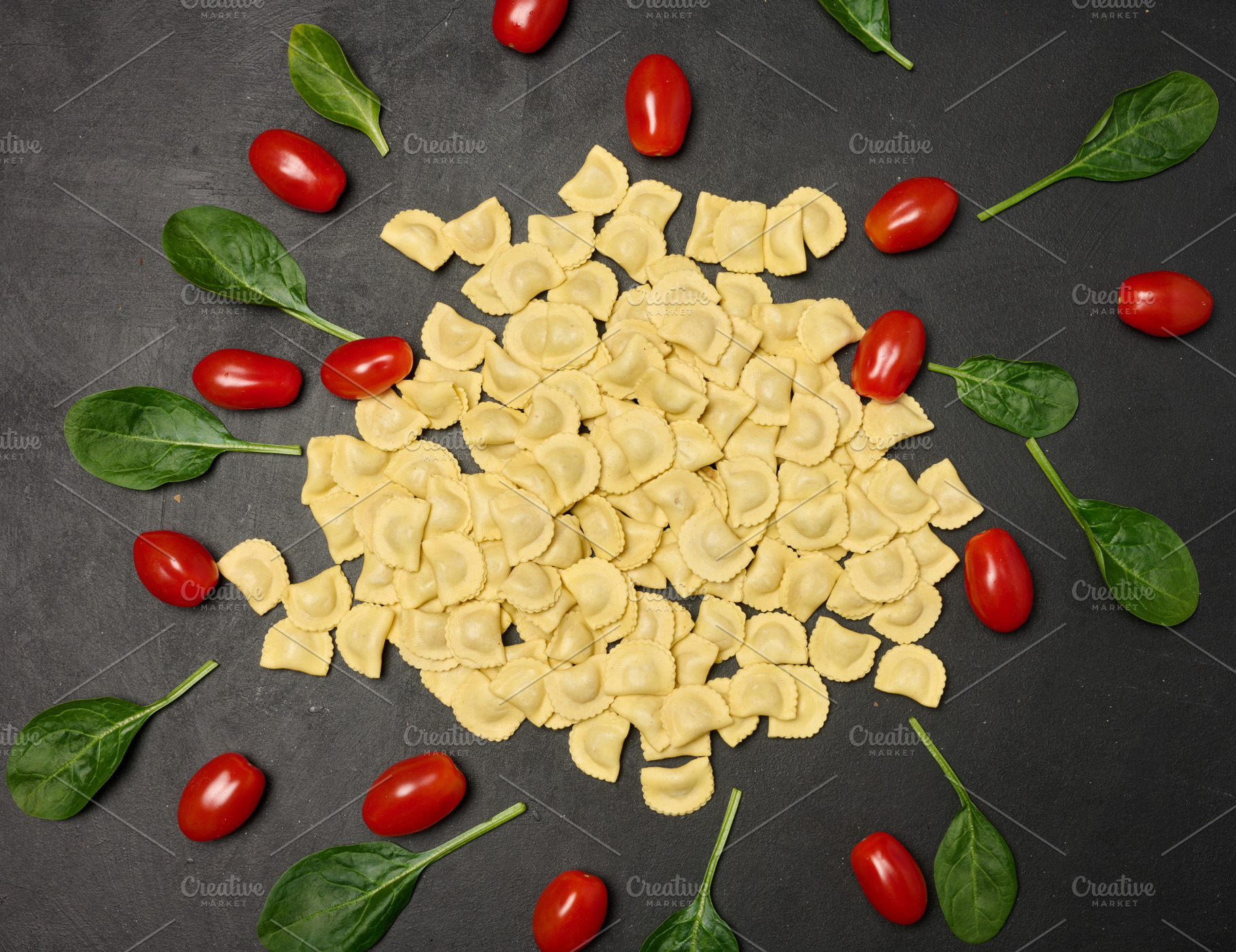Uncooked tortellini pasta with fresh cherry tomatoes and spinach, a Food & Drink Photo by ndanko
