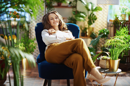 relaxed woman with long wavy hair in house in sunny day, a Person Photo by Alliance Images