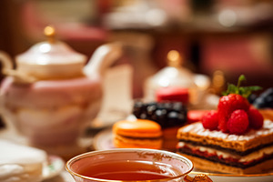 Afternoon tea service with gourmet pastries, macarons, and hot t, a Food & Drink Photo by Studio ANNA