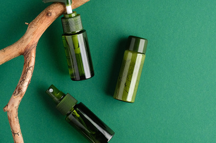 Green cosmetics bottles and branch, a Beauty & Fashion Photo by photoguns