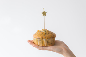 Birthday cupcake with a lit candle