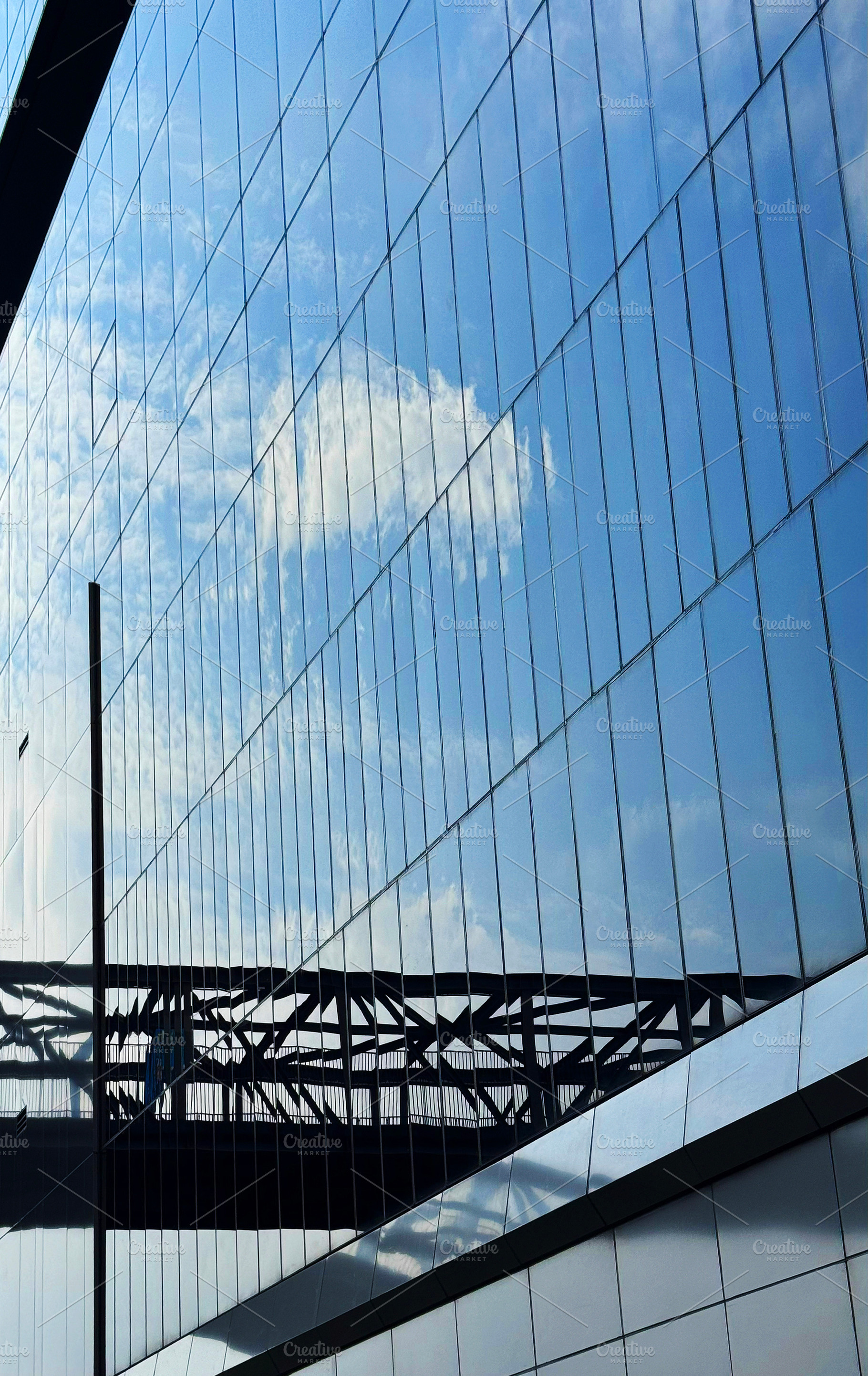 Tall building reflecting the sky, an Architecture Photo by ArtBackground