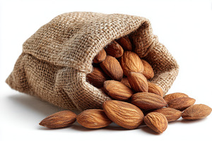 Almonds spilling from burlap sack he, a Photo by Pixeness Studio
