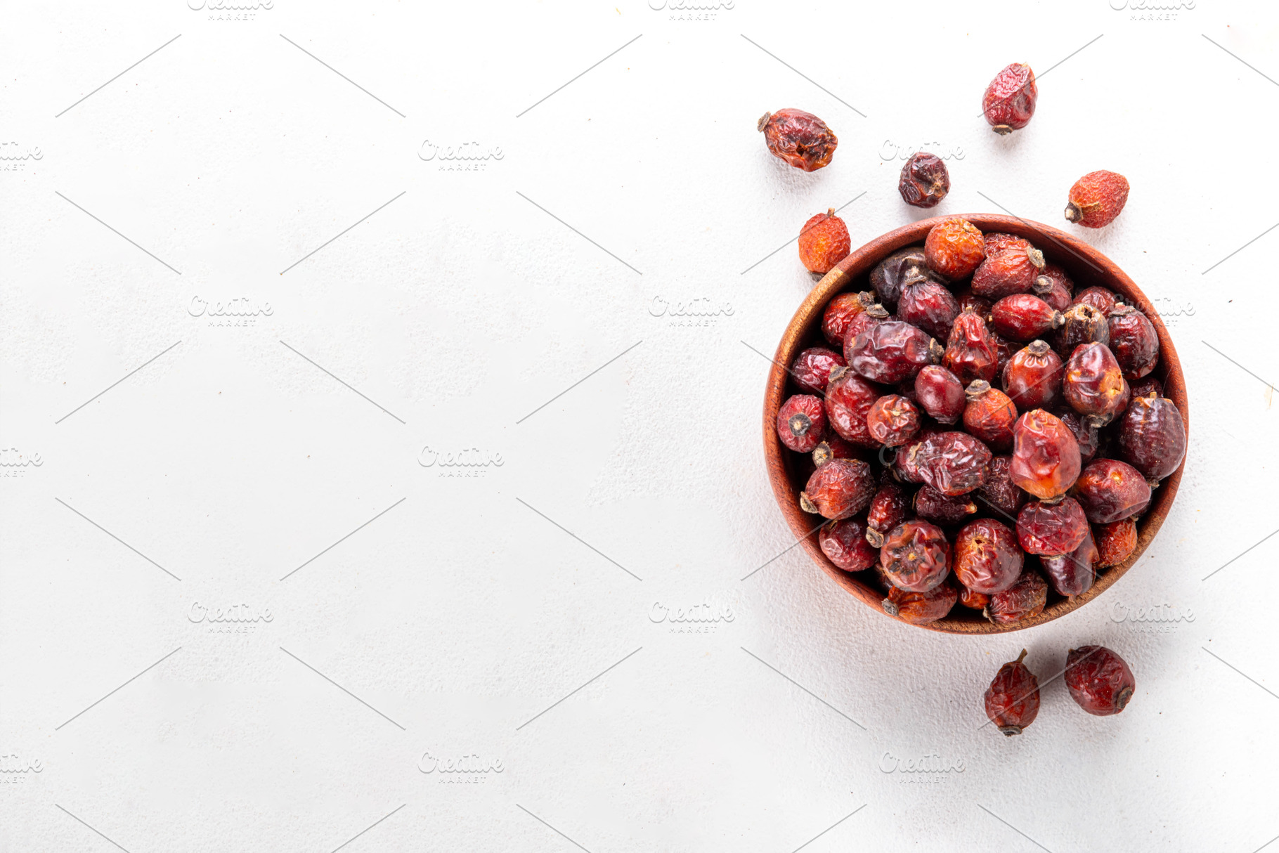 Bowl of dried rose hip berries on white background, a Food & Drink Photo by Rimma