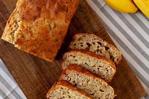Homemade Banana Bread on a wooden board, top view., a Food & Drink Photo by LiudmylaChuhunova